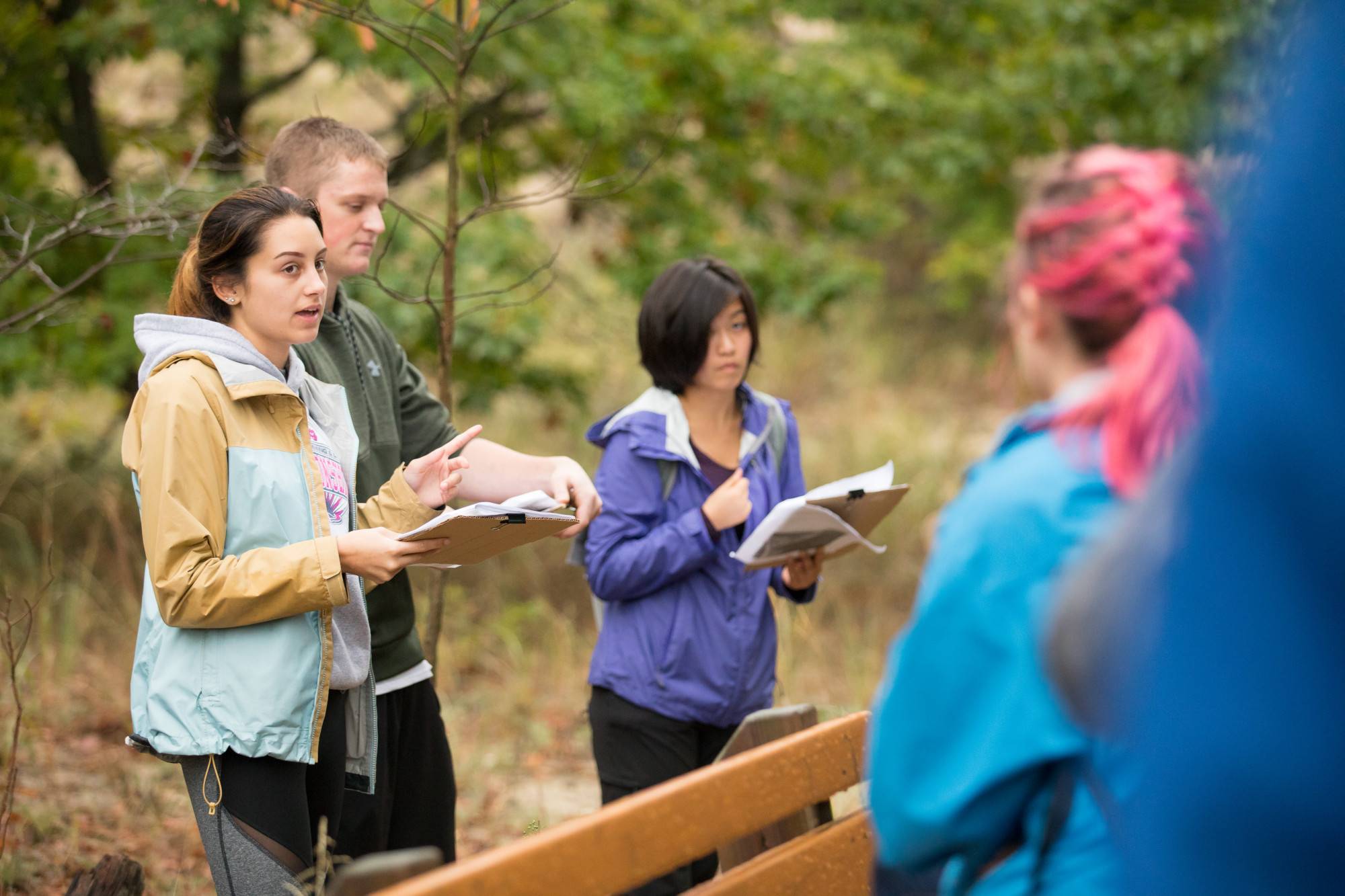 People hiking up rocky trail